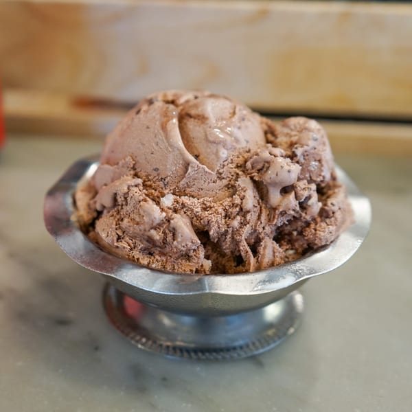 A scoop of Hildebrandt's chocolate chip ice cream in a silver dish.